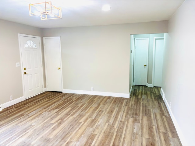 empty room featuring baseboards and wood finished floors