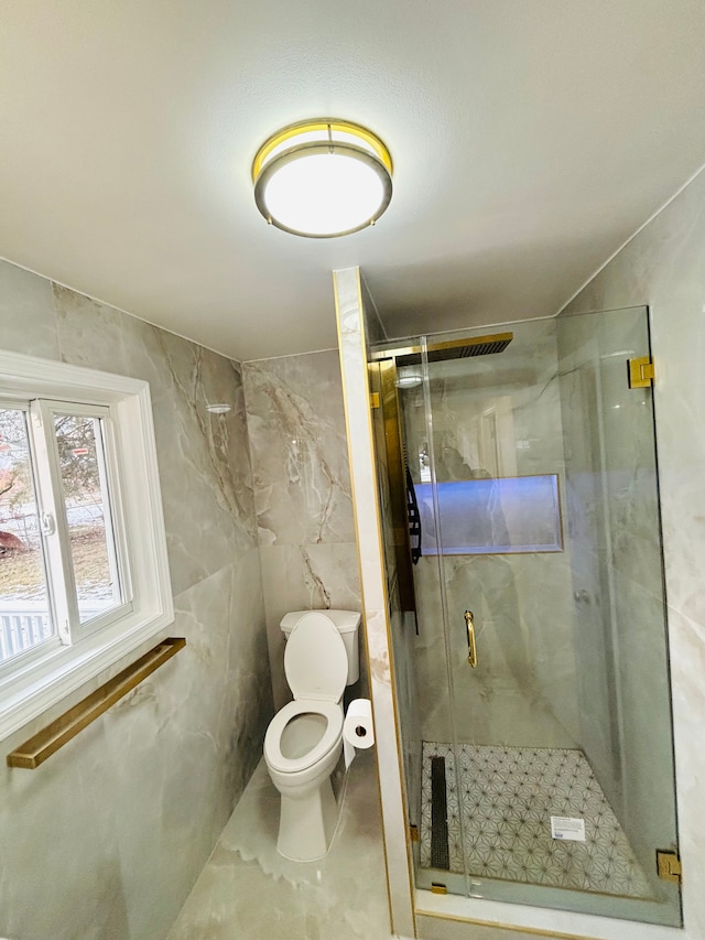 bathroom featuring tile walls, an enclosed shower, and toilet