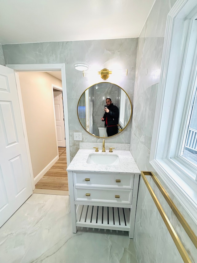 bathroom featuring marble finish floor and vanity