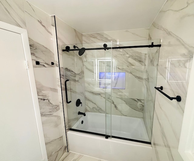 bathroom featuring bath / shower combo with glass door