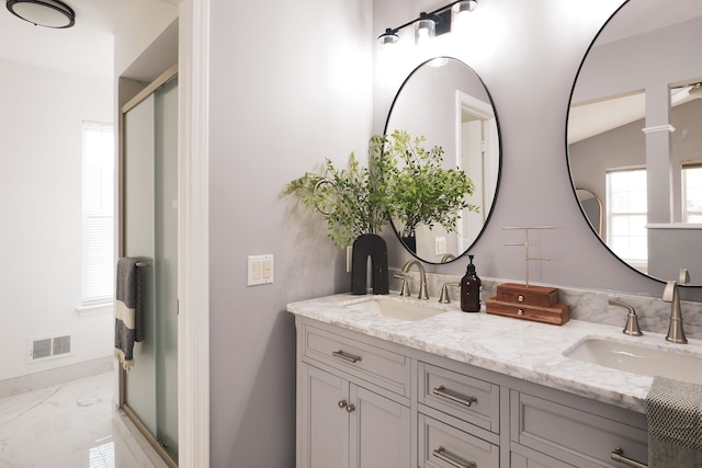 bathroom with vanity and a shower with shower door