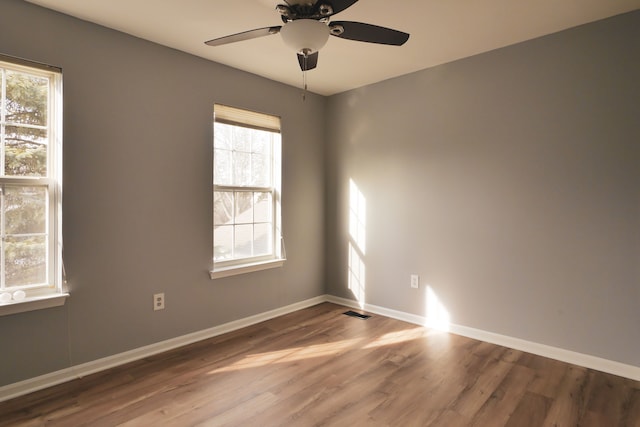 unfurnished room with ceiling fan and wood-type flooring