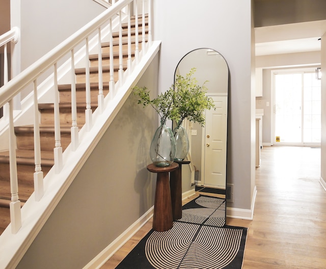 staircase featuring wood-type flooring