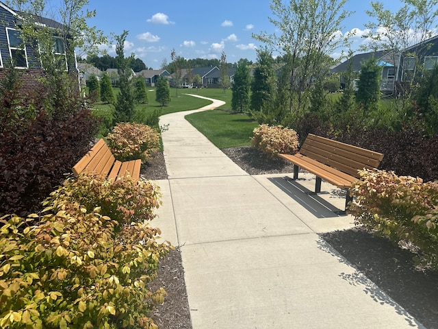 view of home's community with a yard