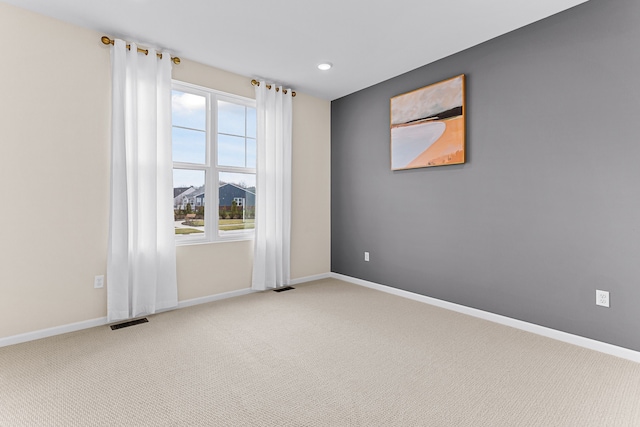 unfurnished room featuring light colored carpet