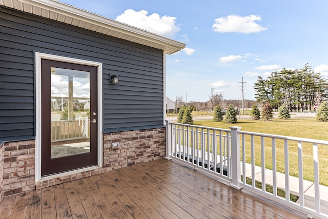 wooden deck with a lawn