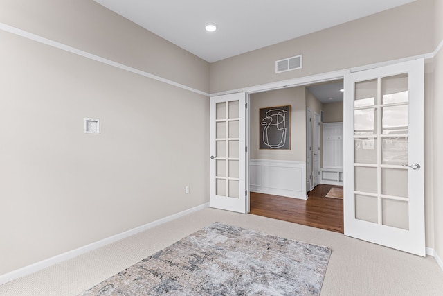 empty room with carpet flooring and french doors