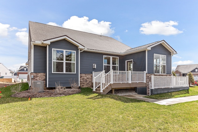 rear view of property with cooling unit, a lawn, and a deck