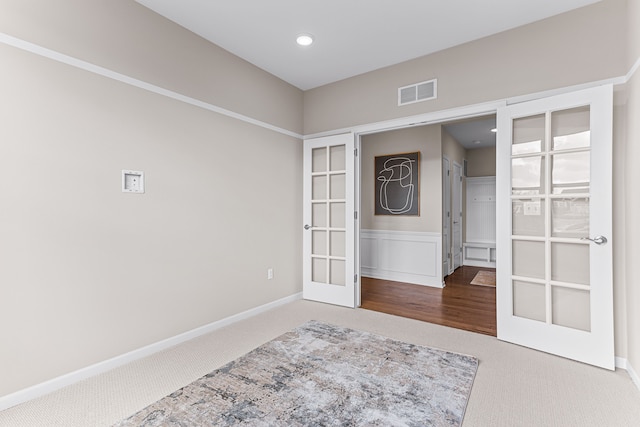 spare room with french doors and carpet floors