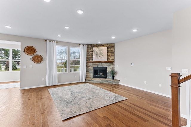 unfurnished living room featuring a fireplace and light hardwood / wood-style floors