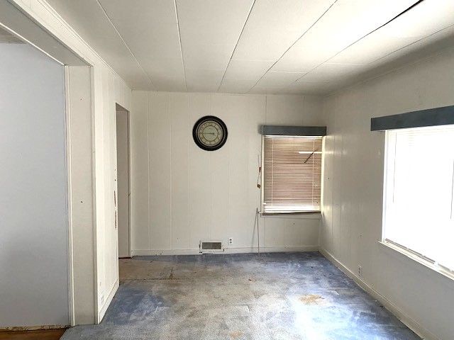 unfurnished room with concrete flooring