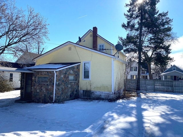 view of snow covered back of property