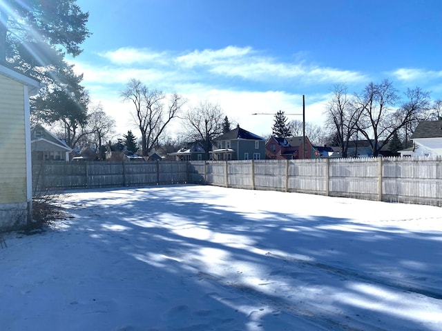 view of yard layered in snow