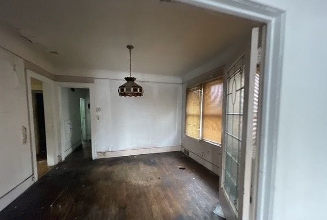 unfurnished dining area featuring dark hardwood / wood-style flooring