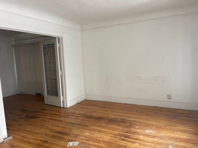 spare room featuring wood-type flooring