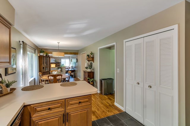 kitchen featuring dark wood-type flooring and pendant lighting