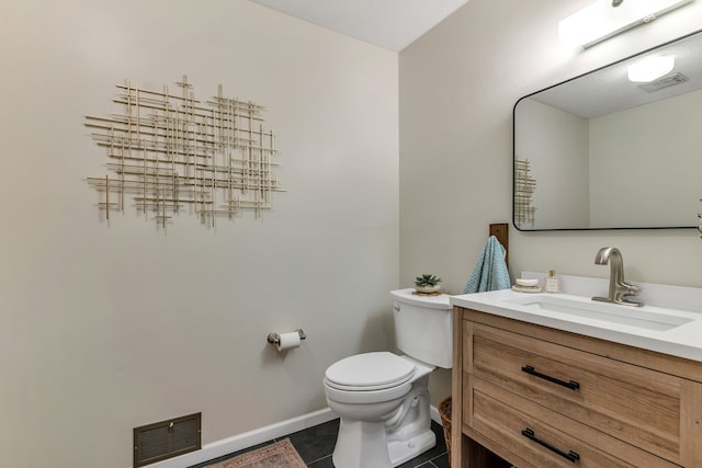 bathroom with vanity, tile patterned floors, and toilet