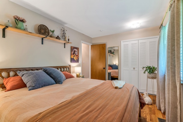 bedroom with hardwood / wood-style flooring and a closet