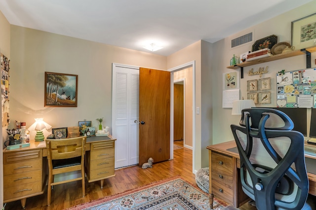 home office with dark hardwood / wood-style floors