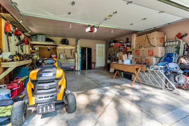 garage featuring a garage door opener and a workshop area