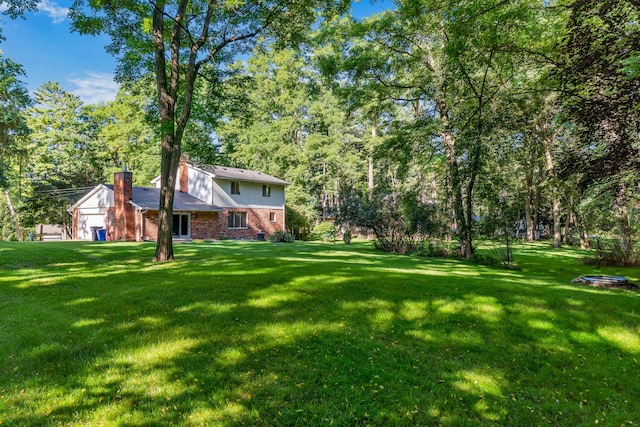 view of yard with a fire pit