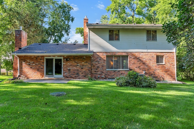 back of property with a patio and a lawn