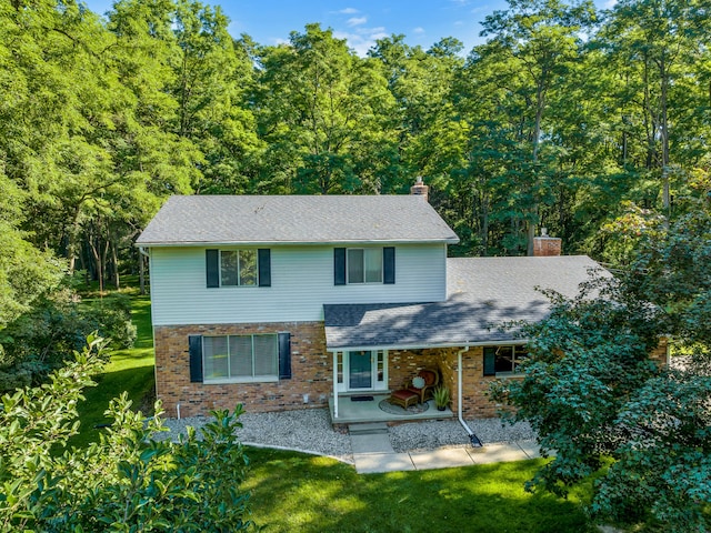 front facade with a front lawn and a patio