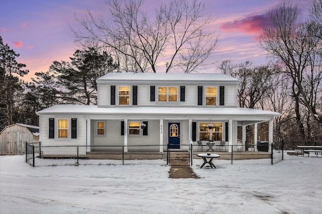 country-style home with a shed and covered porch