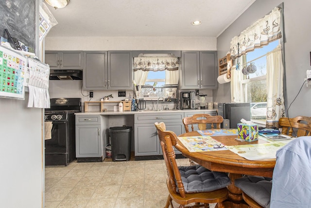 kitchen with black range with gas cooktop, sink, and gray cabinetry