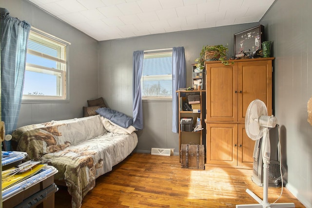 sitting room with plenty of natural light and dark hardwood / wood-style floors