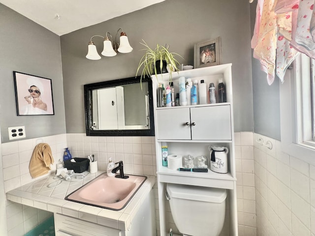 bathroom featuring sink, tile walls, and toilet