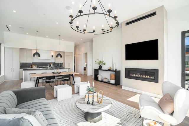 living room featuring a towering ceiling and light wood-type flooring