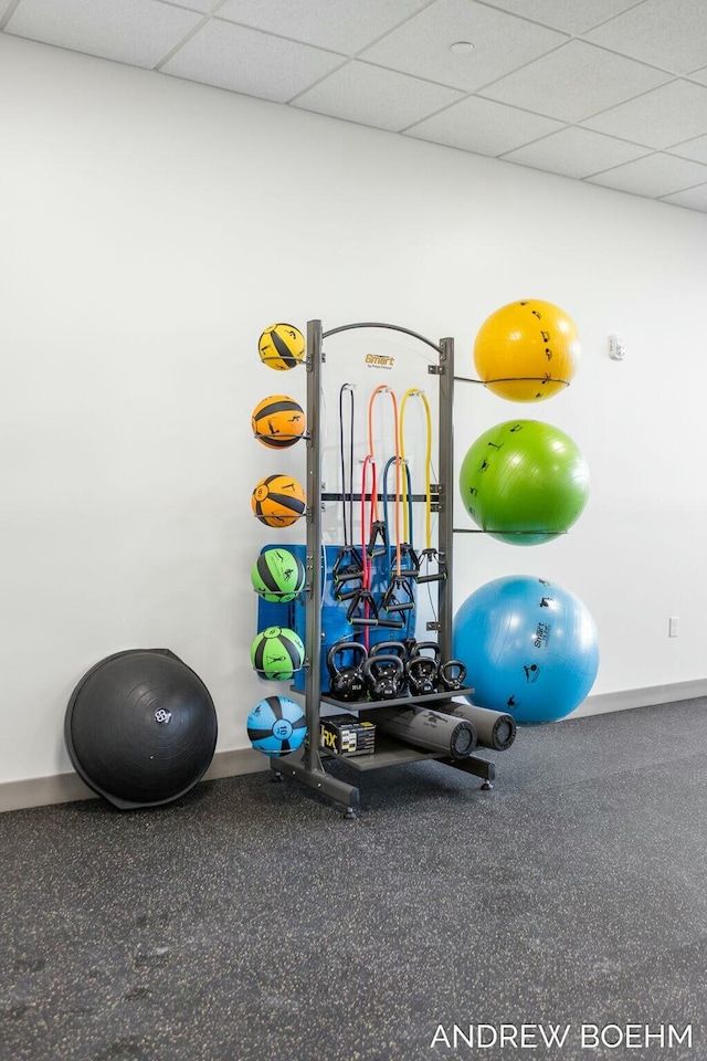 workout room with a paneled ceiling