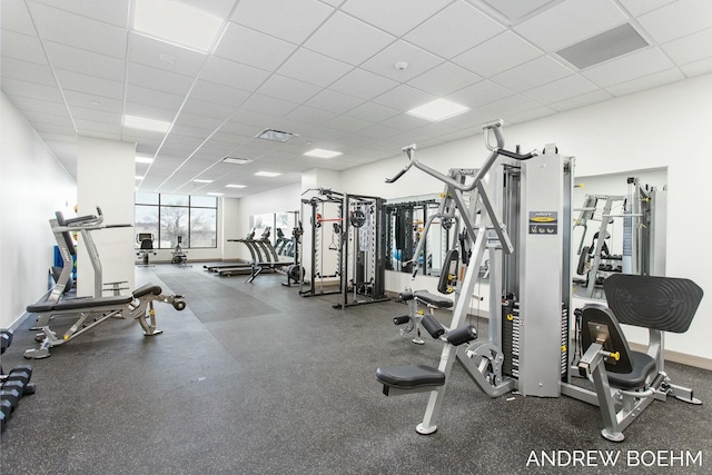 exercise room with a paneled ceiling