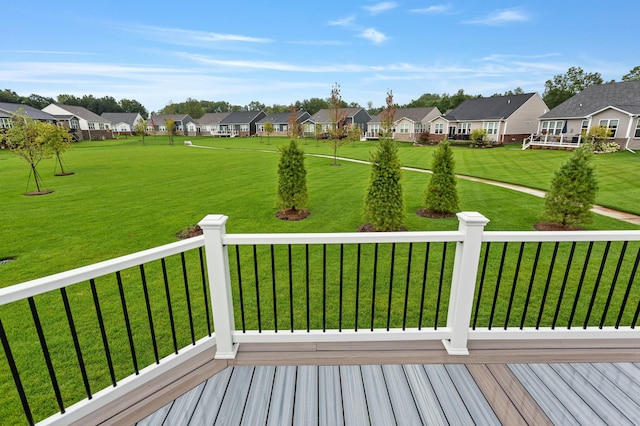 wooden terrace with a lawn