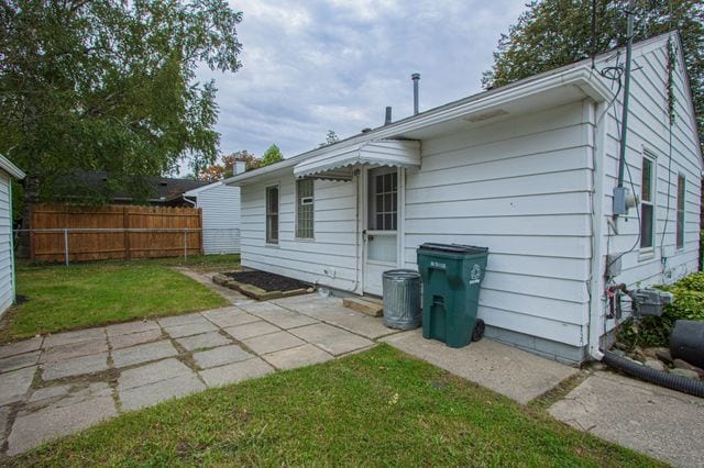 view of side of home featuring a yard