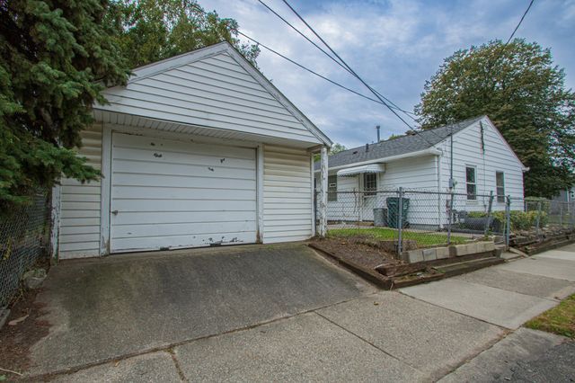 view of front of house featuring a garage and an outdoor structure