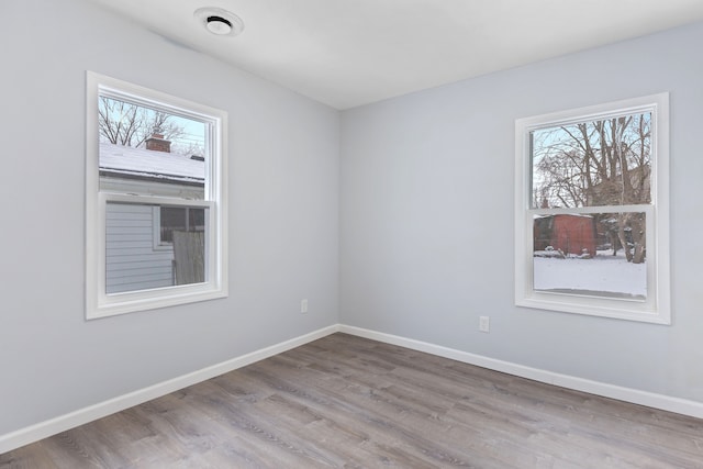 empty room featuring a healthy amount of sunlight and light wood-type flooring