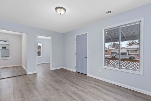 unfurnished room with light wood-type flooring