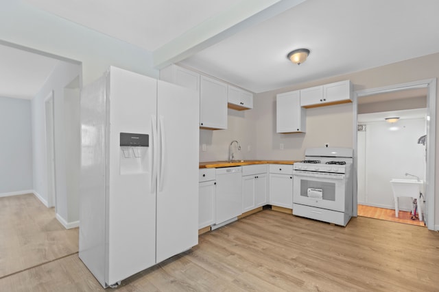 kitchen featuring white cabinetry, sink, white appliances, and light hardwood / wood-style floors