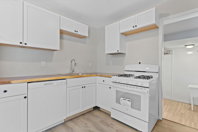 kitchen with sink, white appliances, wooden counters, light hardwood / wood-style floors, and white cabinets