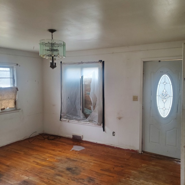 entrance foyer featuring hardwood / wood-style flooring and an inviting chandelier