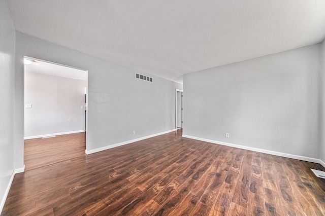 unfurnished room with dark hardwood / wood-style floors