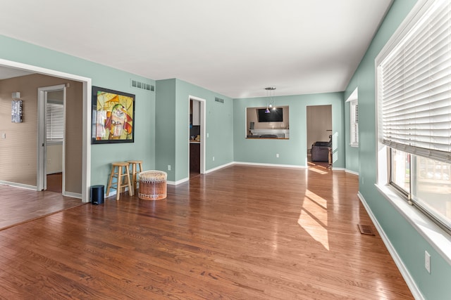 unfurnished living room with hardwood / wood-style flooring