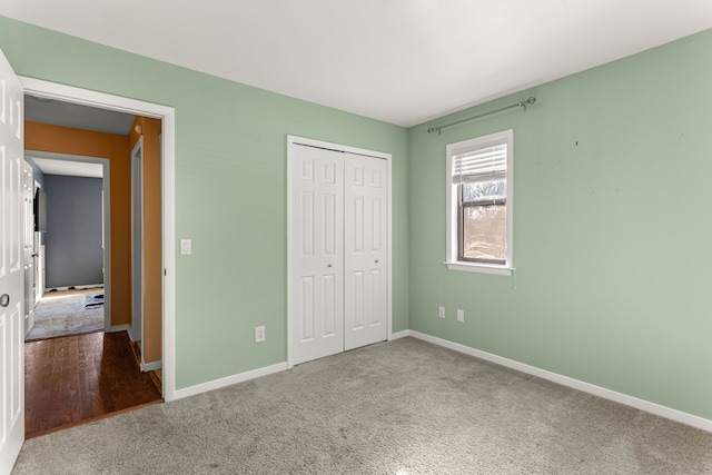 unfurnished bedroom with carpet floors and a closet