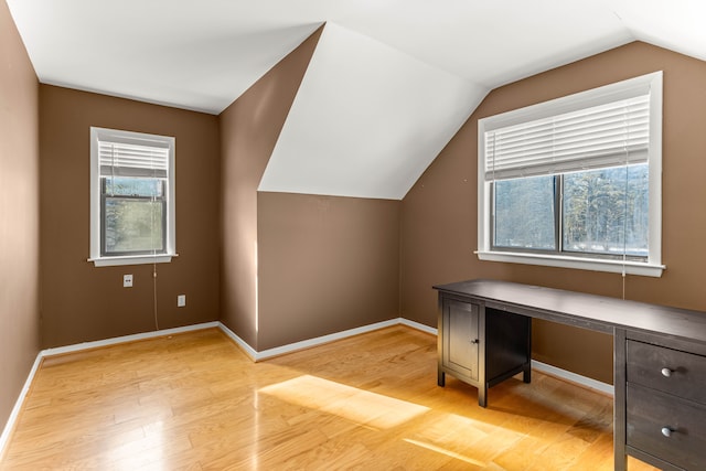 bonus room featuring lofted ceiling and light hardwood / wood-style flooring