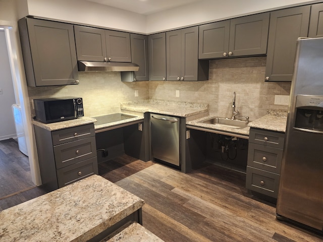 kitchen with sink, decorative backsplash, light stone counters, black appliances, and dark wood-type flooring