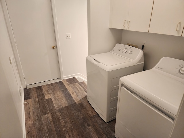 washroom with dark hardwood / wood-style flooring, cabinets, and washer and dryer