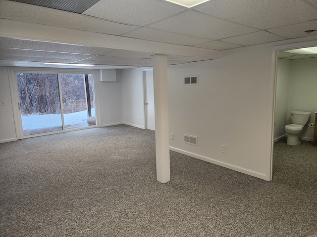 basement with a drop ceiling and carpet flooring