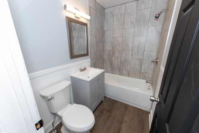 full bathroom featuring vanity, wood-type flooring, toilet, and tiled shower / bath